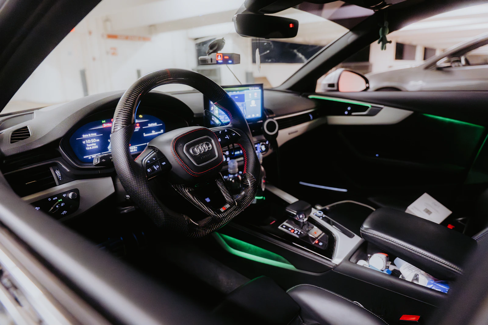 Modern car interior with blue ambient lighting and dashboard details
