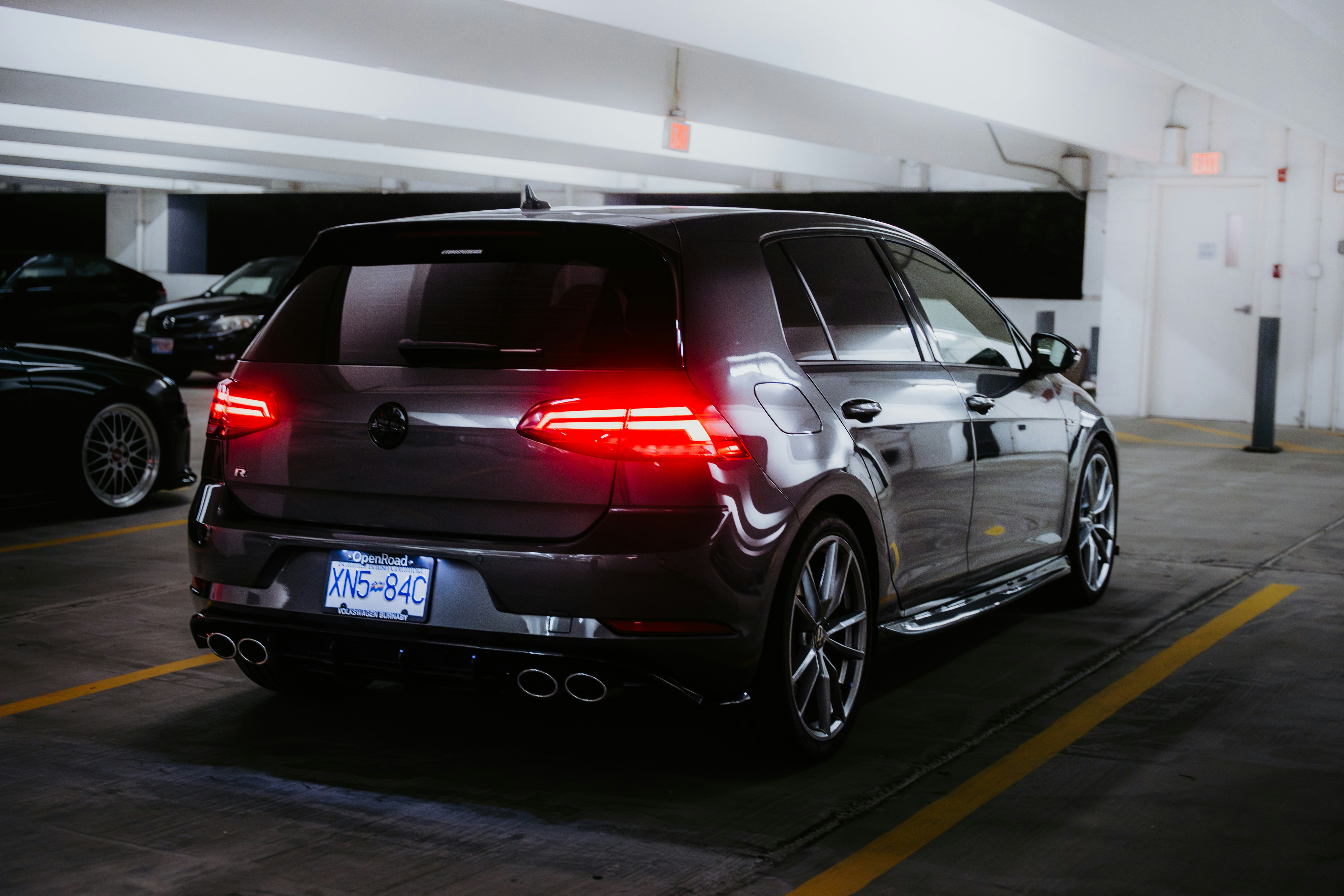 Dark hatchback car parked in a garage.