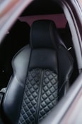 Black leather car seat with diamond stitching