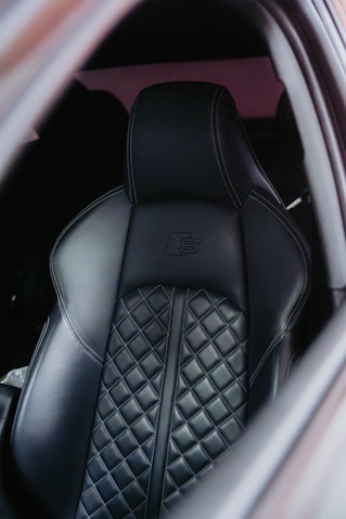 Black leather car seat with diamond stitching