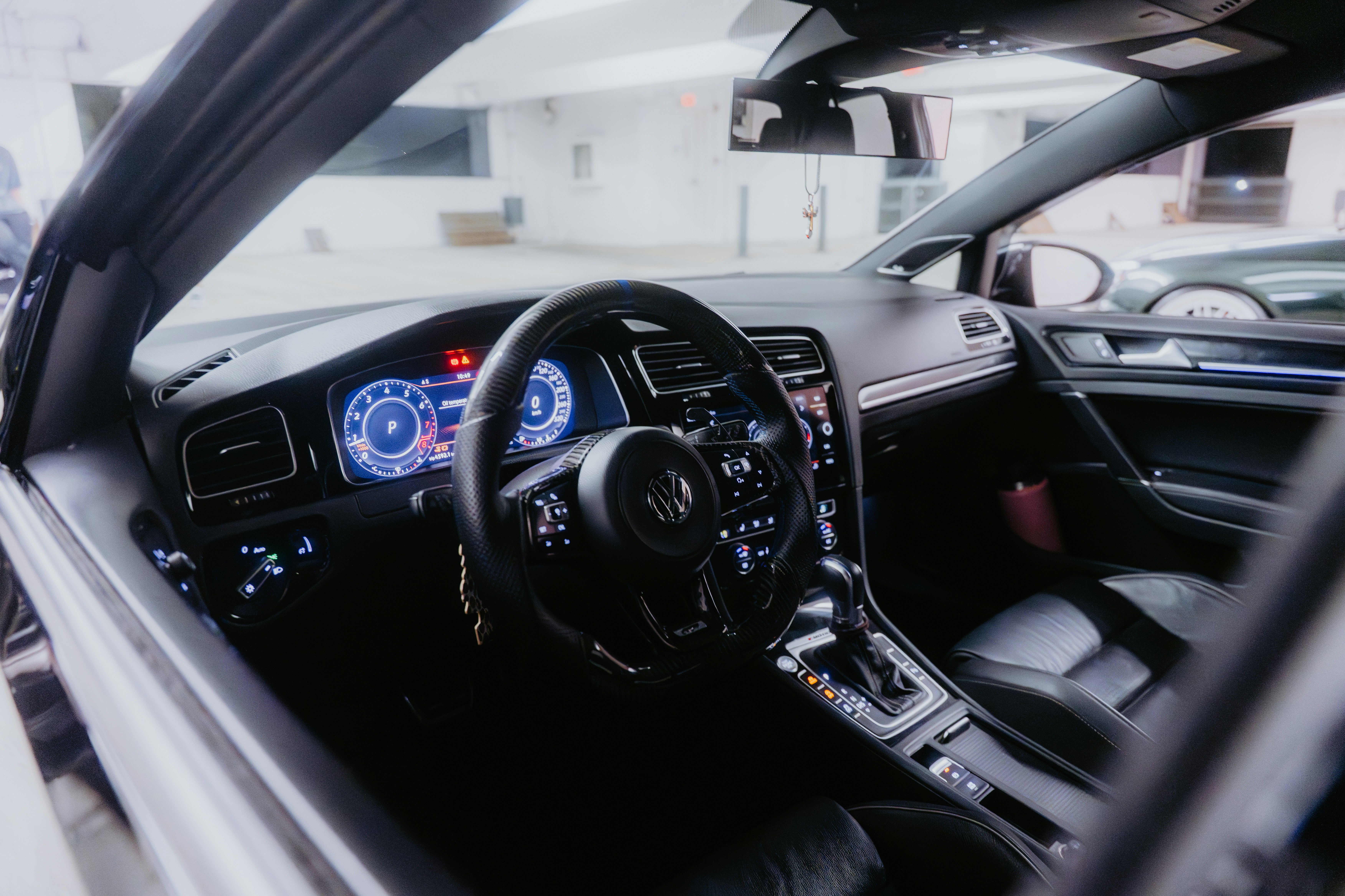 Interior view of a modern car's dashboard and steering wheel.