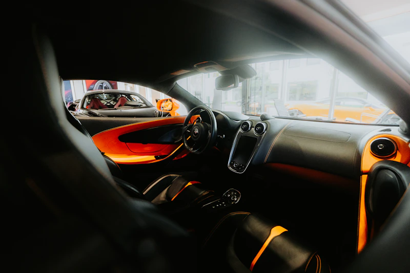 Interior view of a modern sports car with orange accents