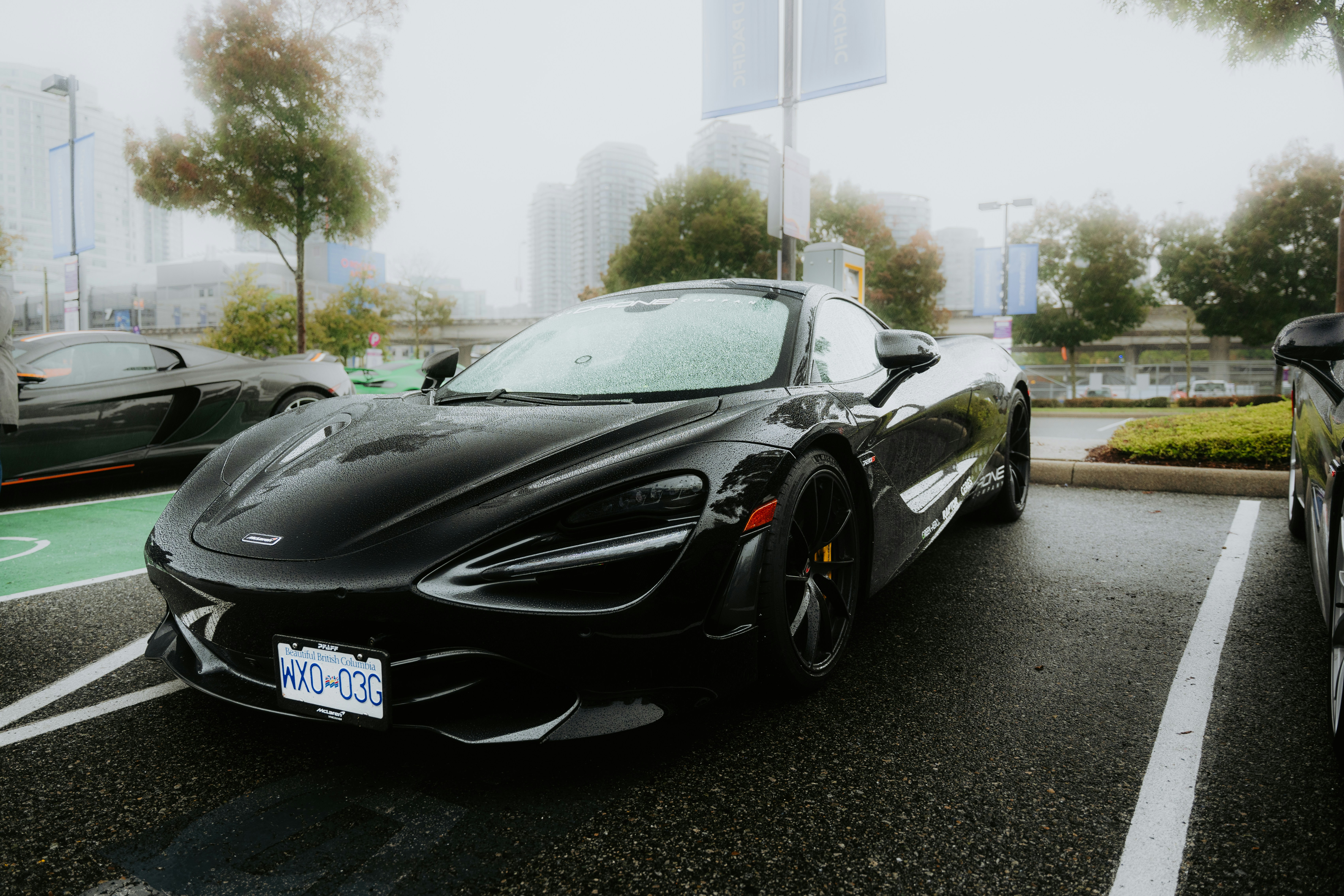 A sleek black sports car parked in a lot.