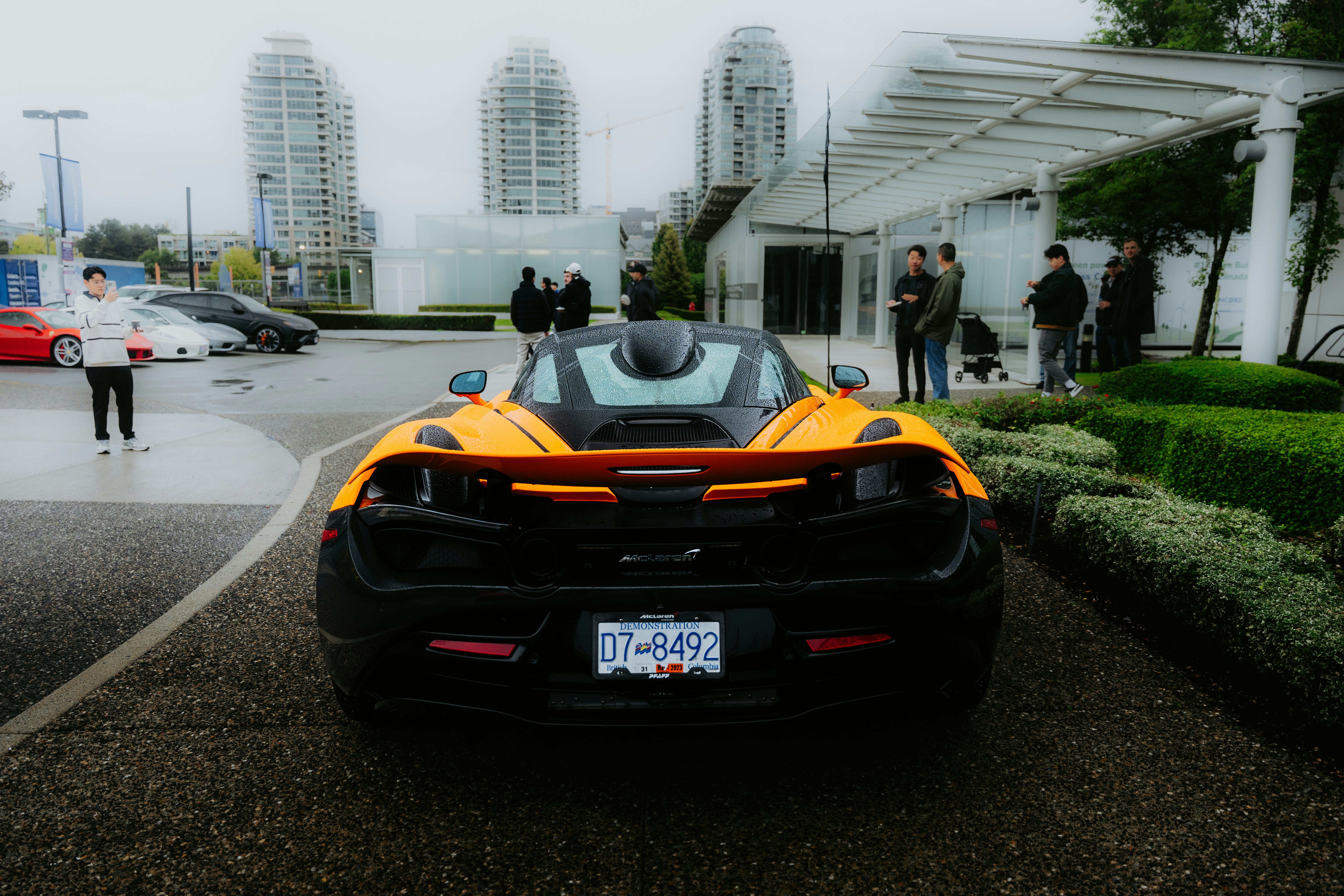 Orange sports car parked outside modern building