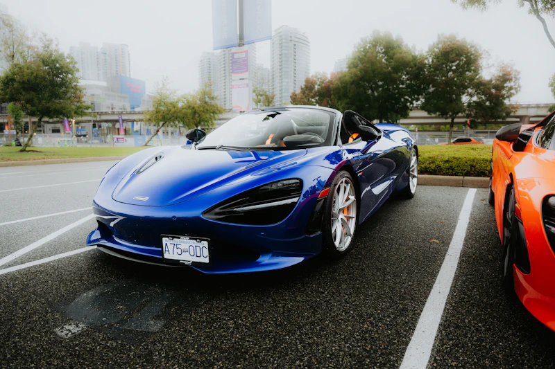 A blue convertible sports car parked outside.
