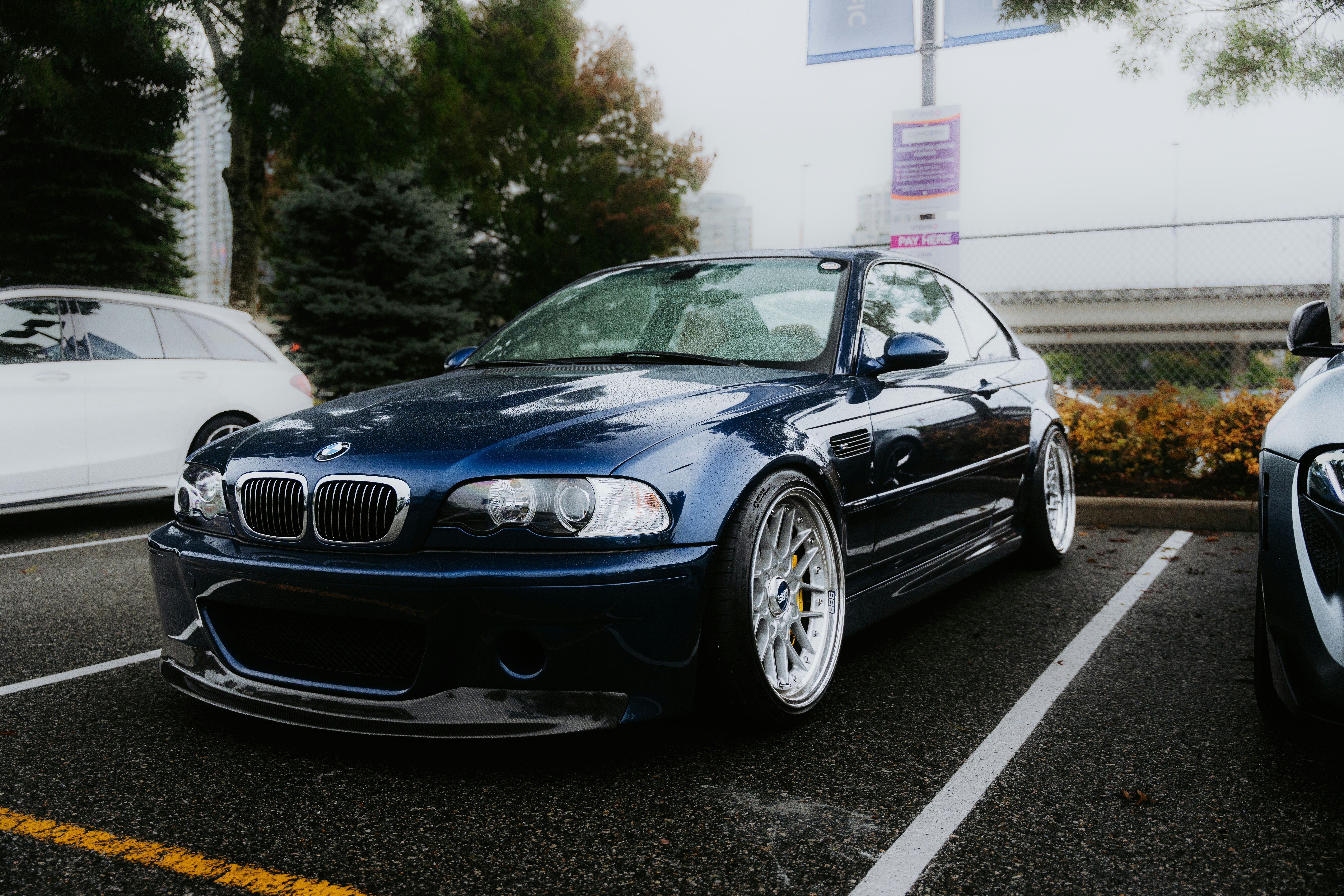 Dark blue BMW parked in a lot.