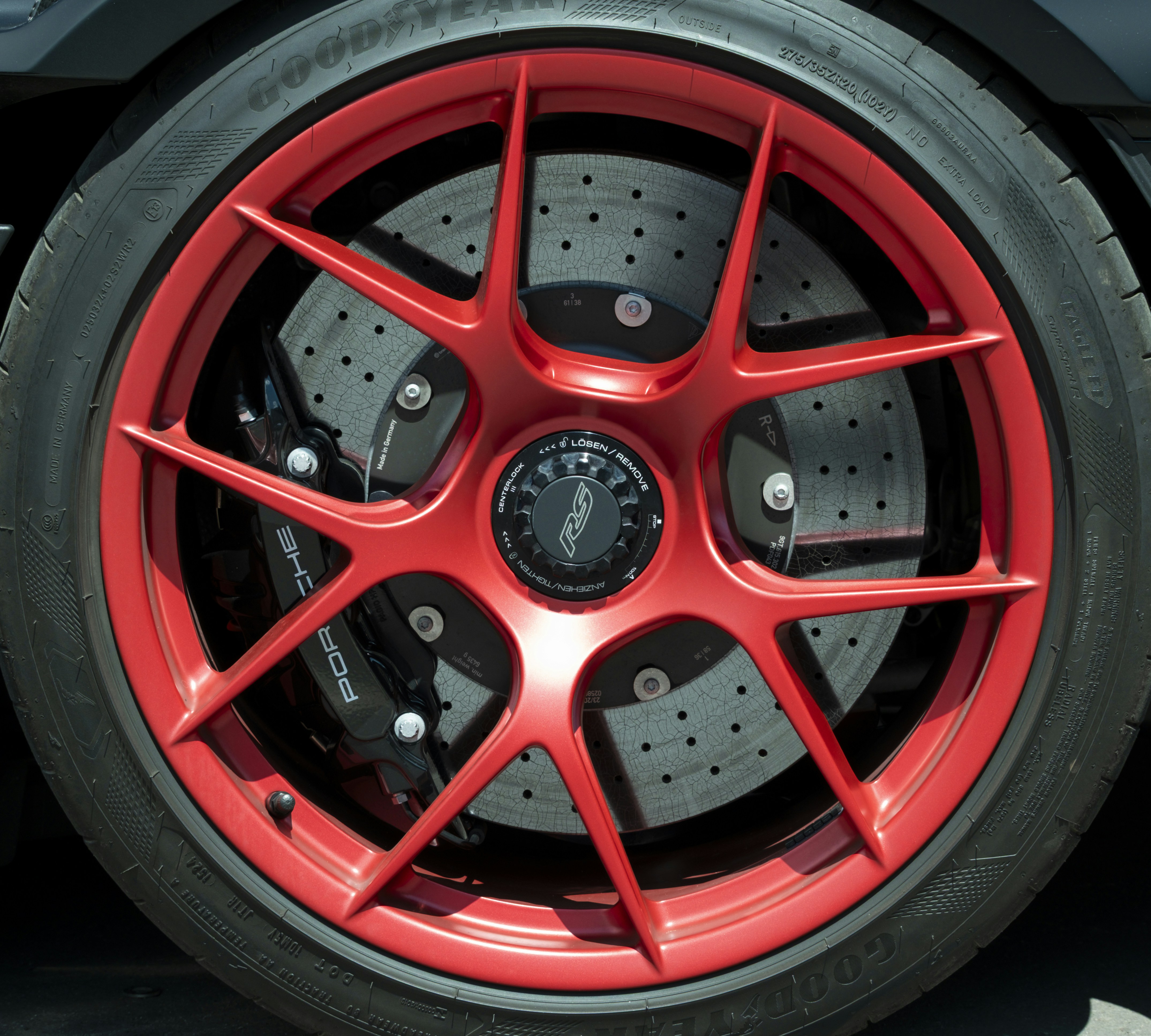 Red sports car wheel and tire