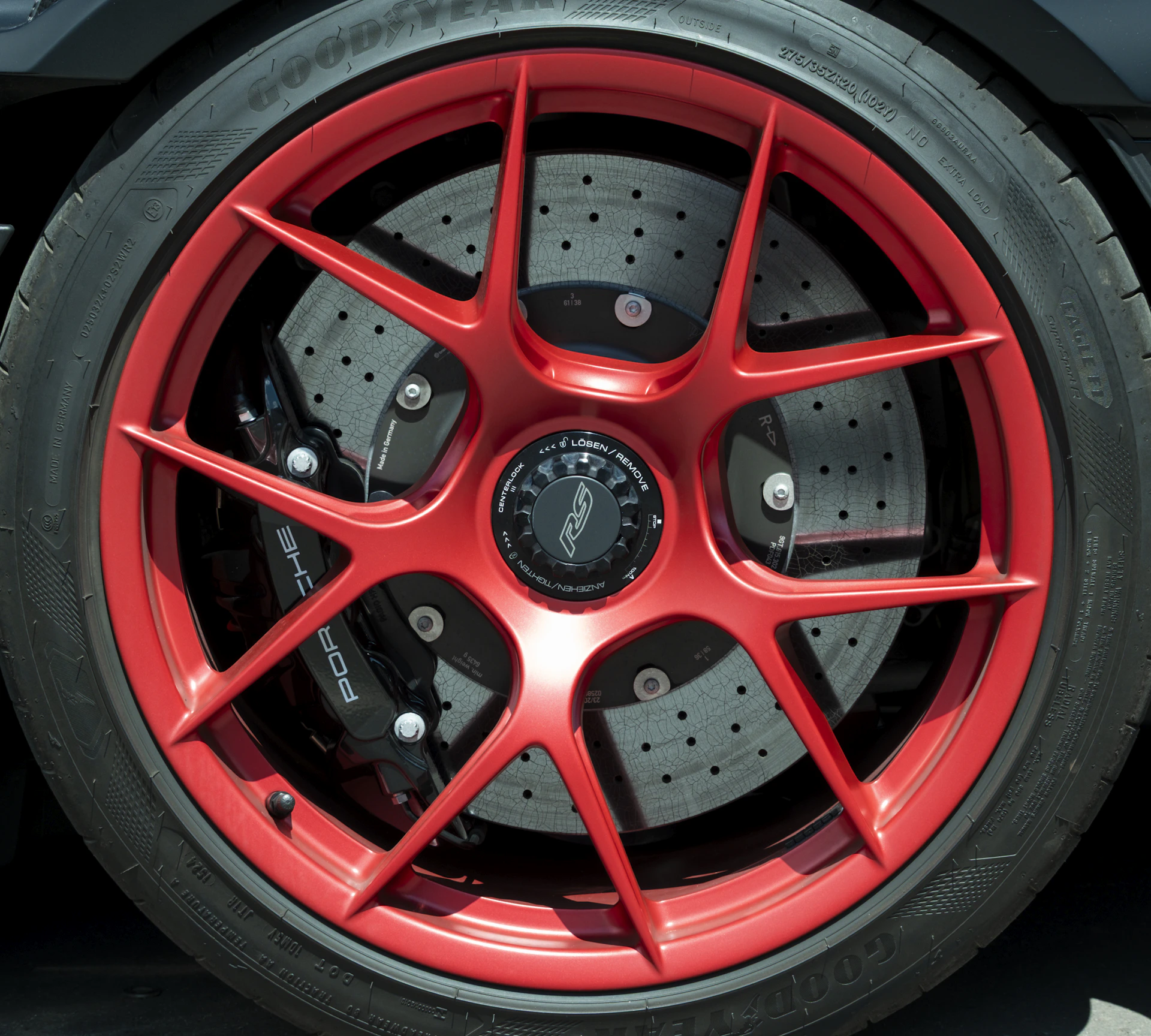 Close-up of a red sports car wheel and tire.
