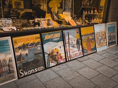 Vintage travel posters displayed outside a shop