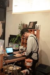 Barista preparing drinks at a coffee counter.