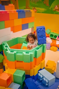 A child plays with large colorful building blocks.