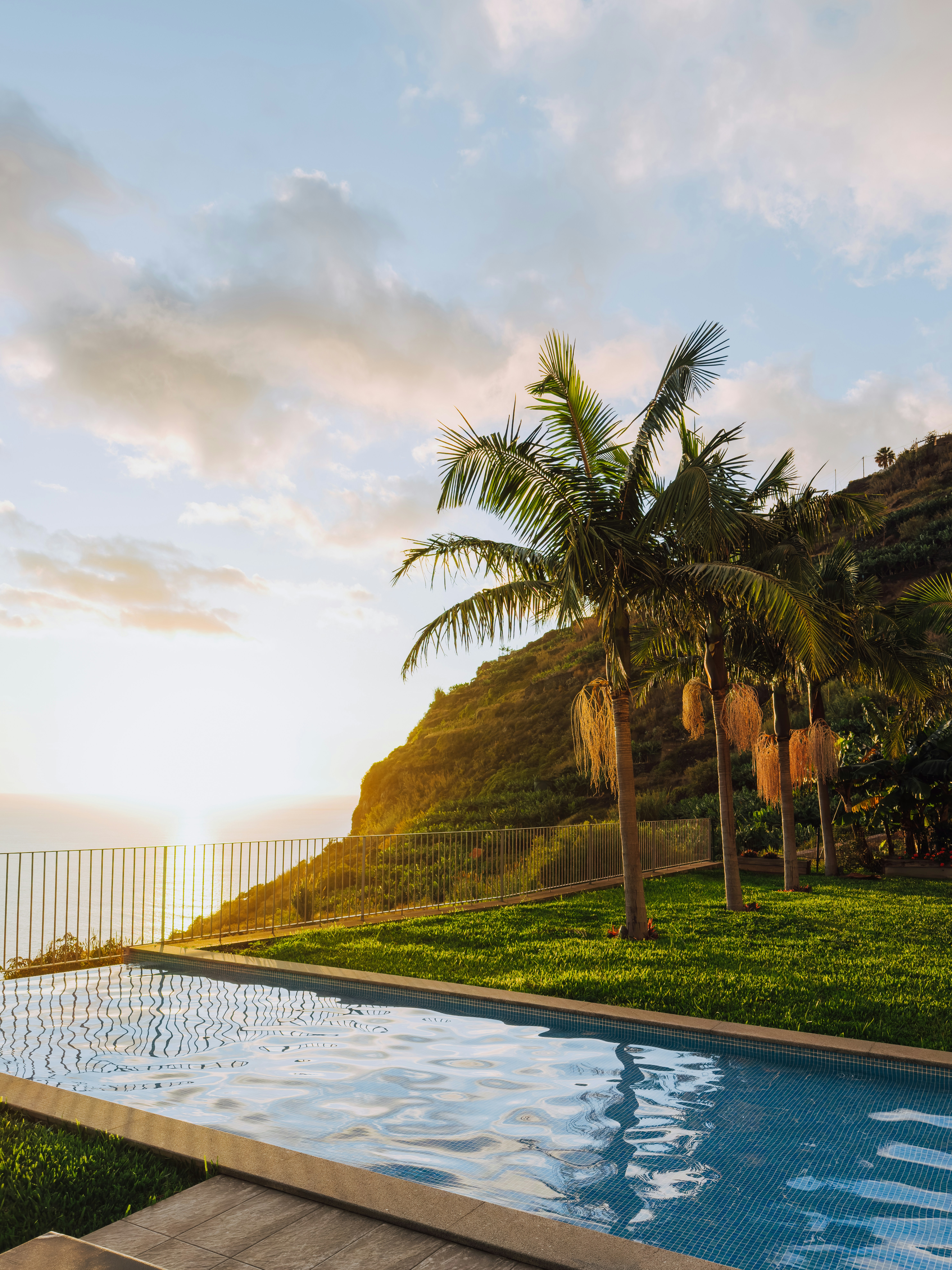 Swimming pool overlooking the ocean at sunset.