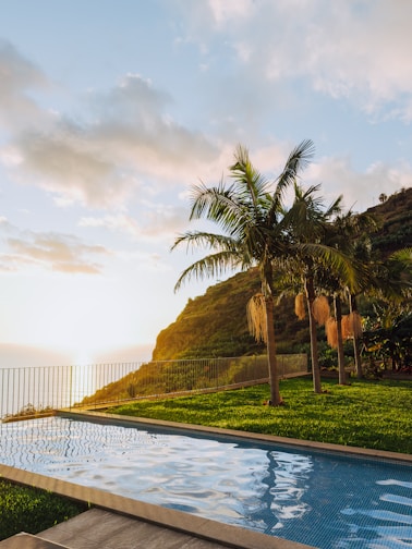 Swimming pool overlooking the ocean at sunset.