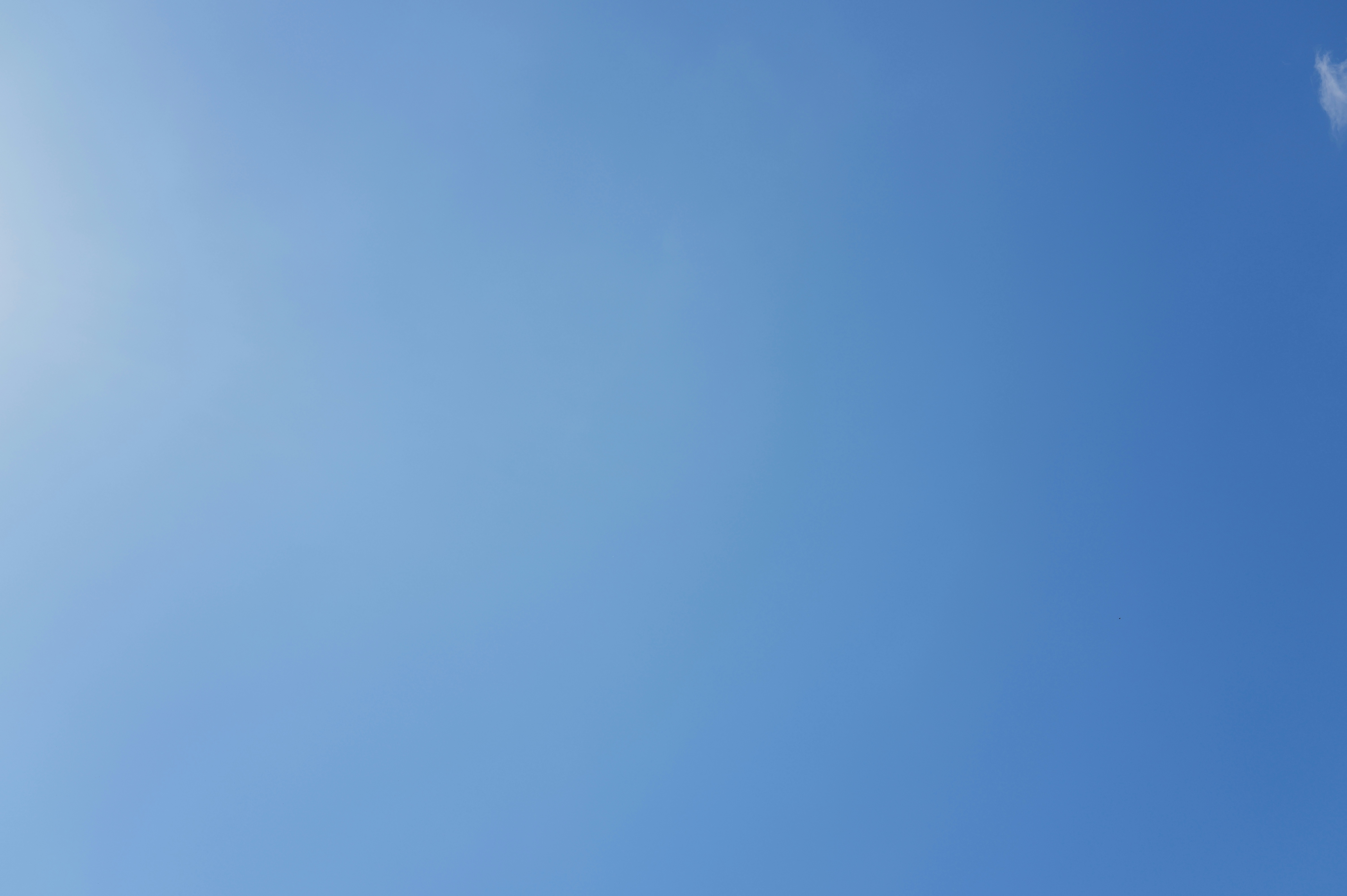 Clear blue sky with a faint sun glare.