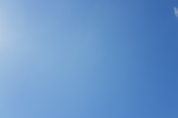 Clear blue sky with a faint sun glare.