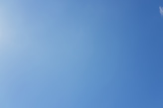 Clear blue sky with a faint sun glare.