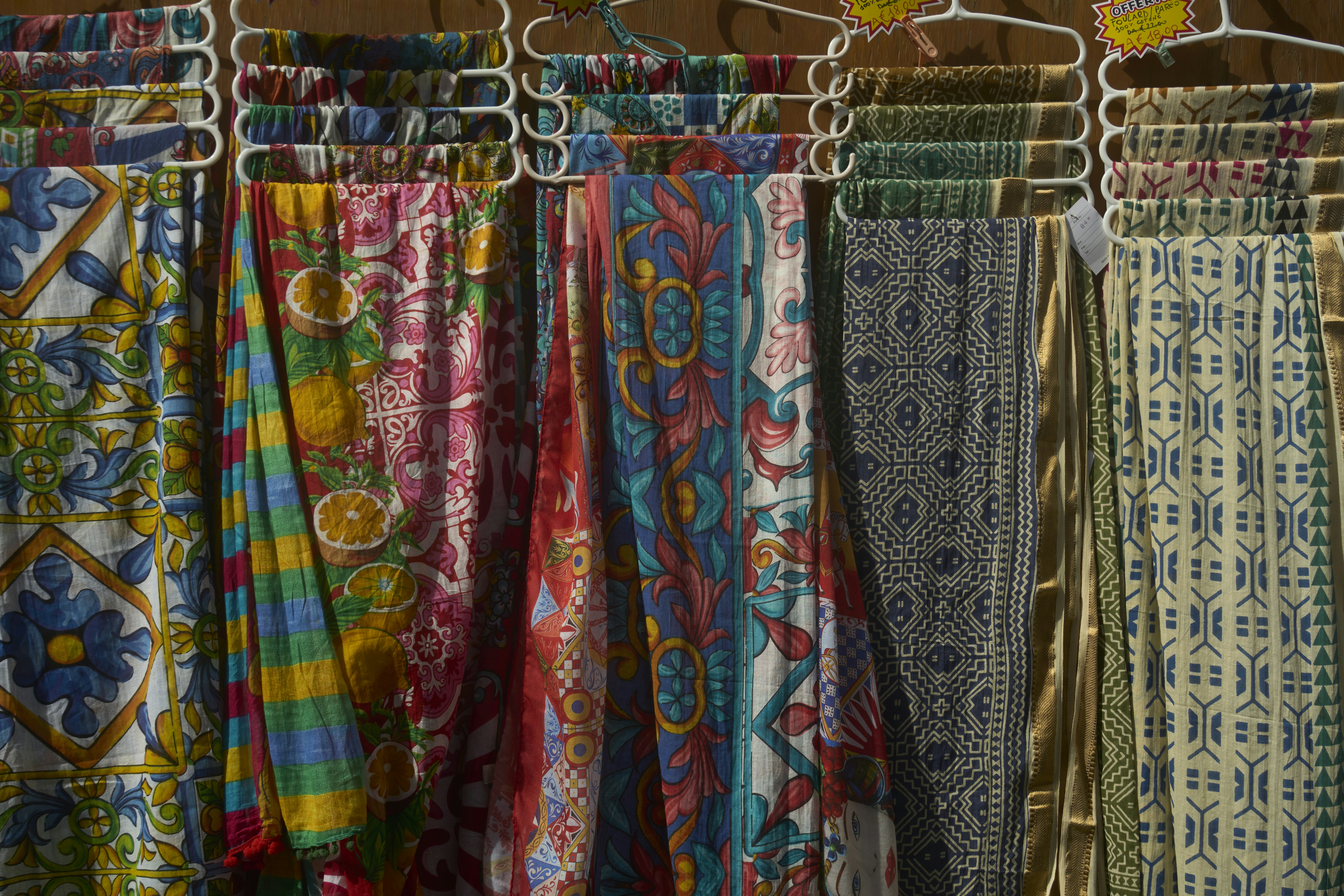 Colorful patterned fabrics hanging on display
