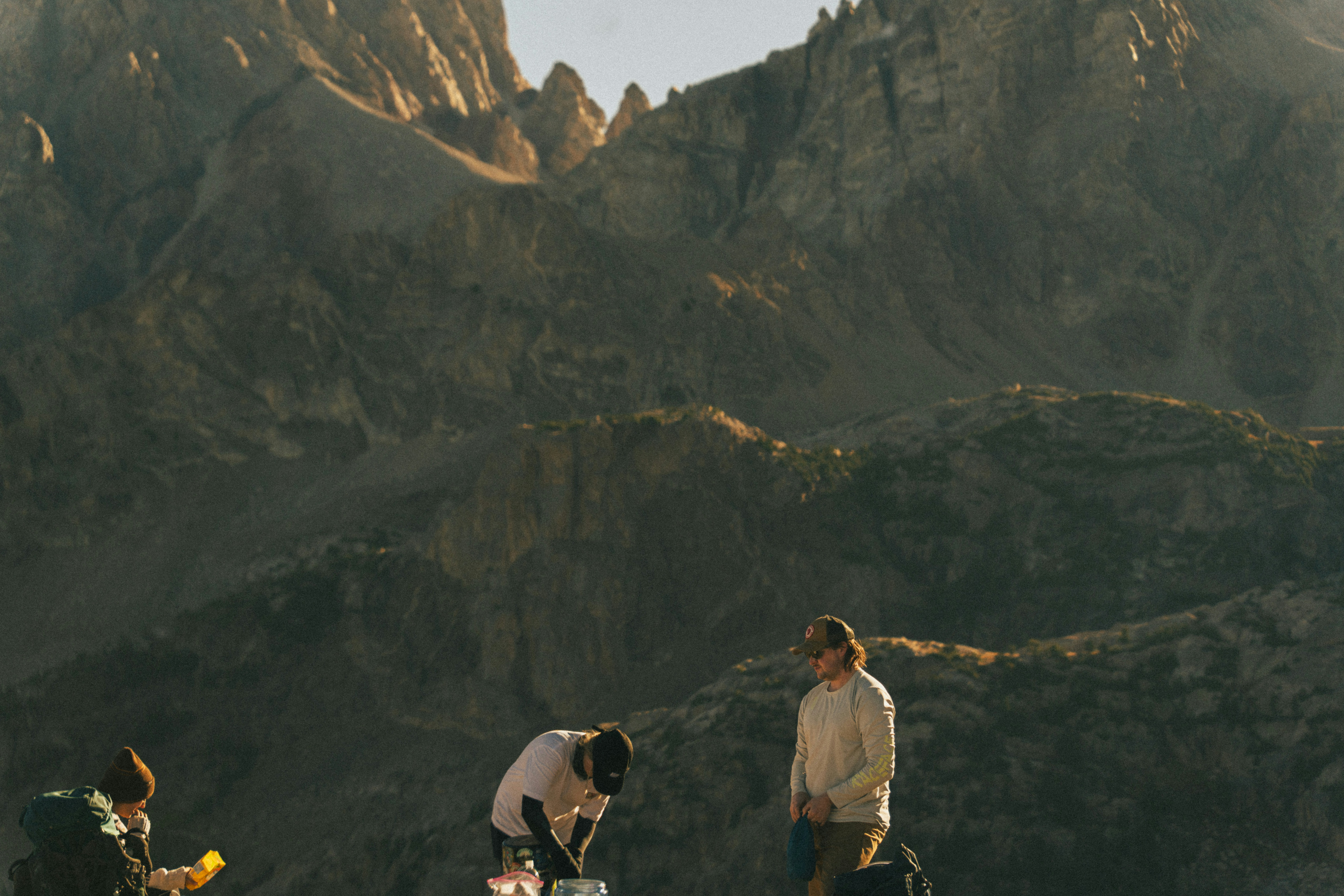 Hikers preparing gear with mountains in background