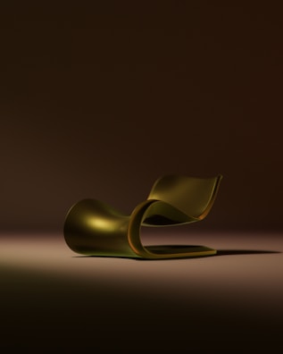 A sleek, golden chaise lounge on a dark background