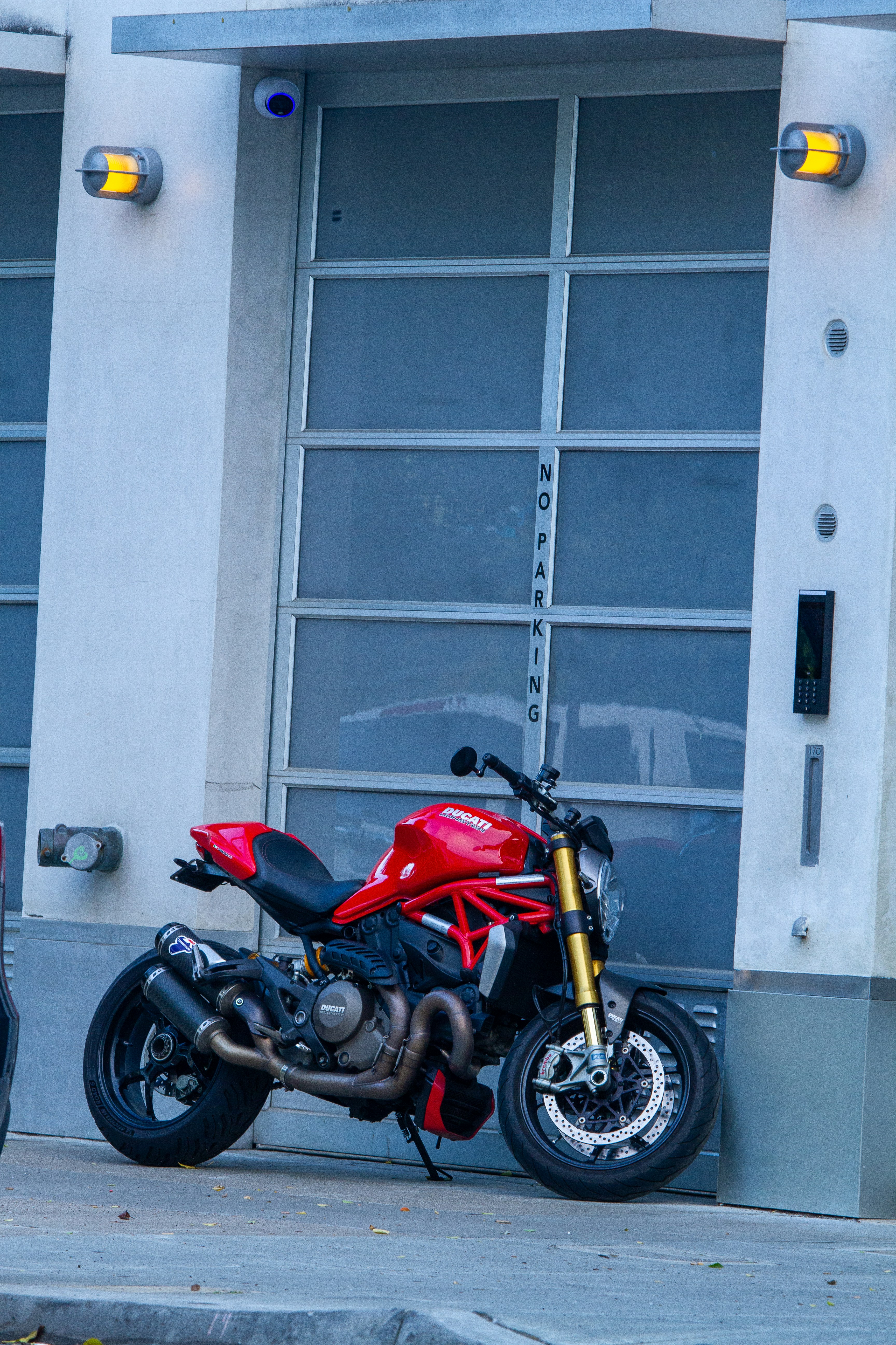 Red motorcycle parked in front of a garage door