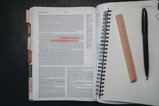 Open book with pen and highlighter on notebook page.