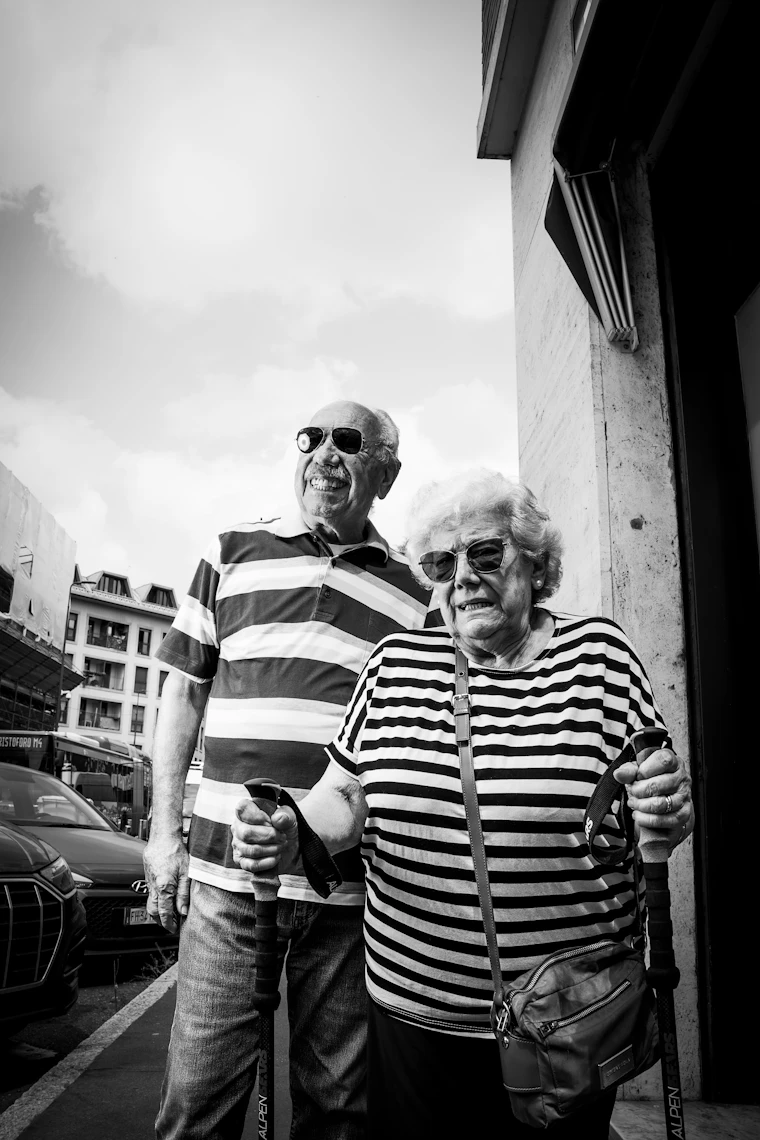 Active senior couple walking with hiking poles outdoors