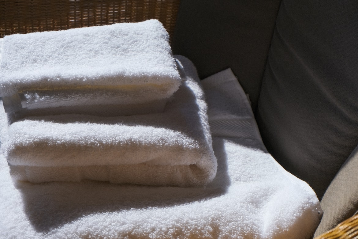Clean white towels stack for laundry tips