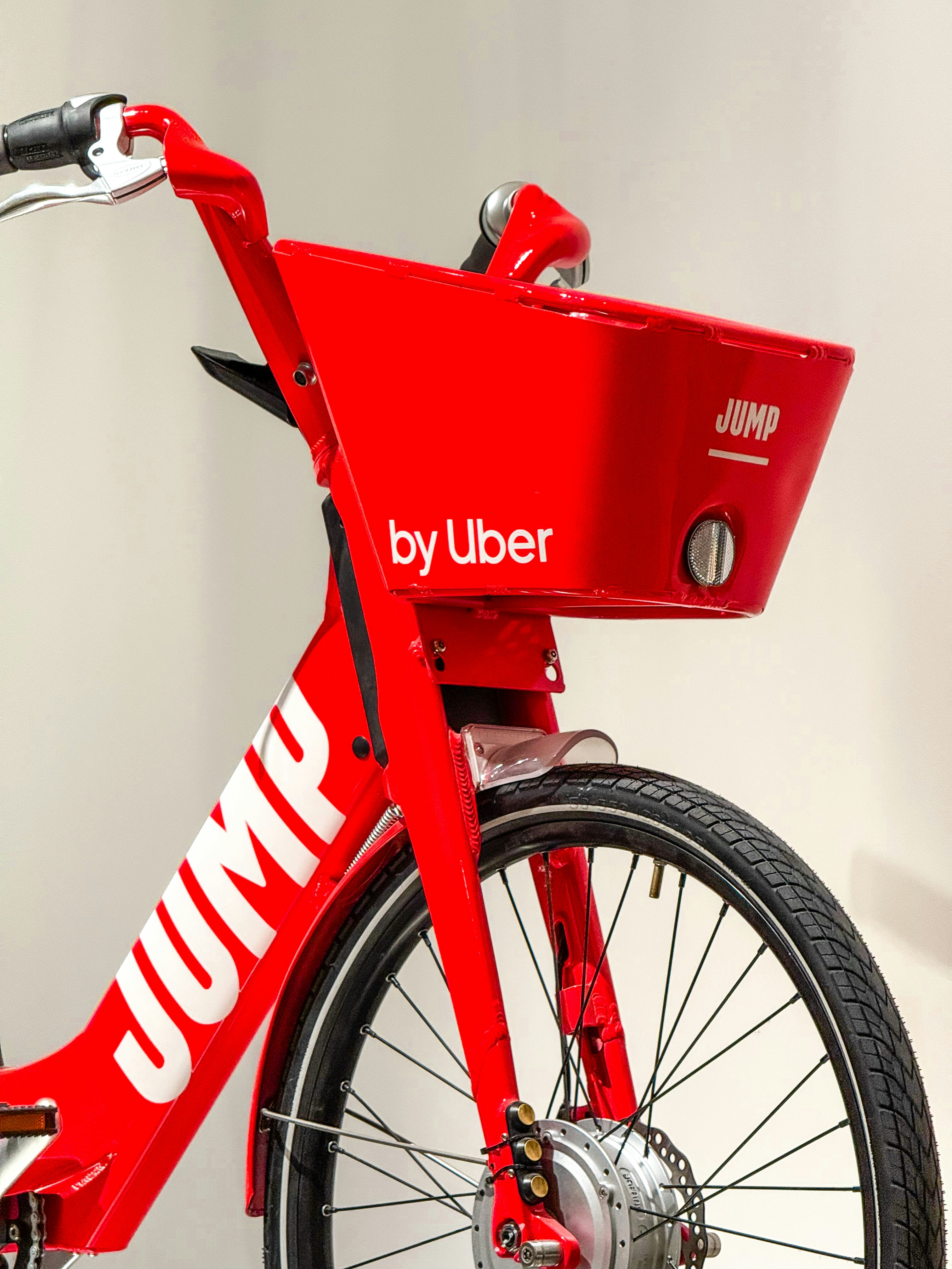 Red jump by uber bicycle with front basket