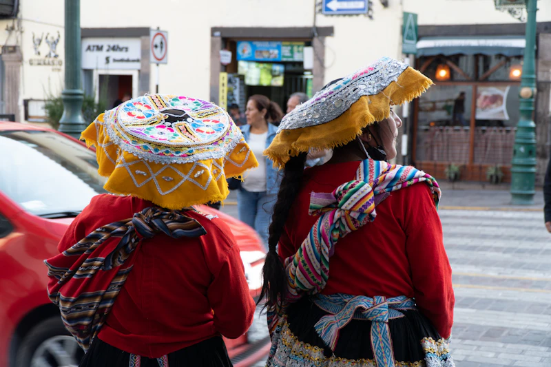 Two Andean women in traditional dress on a Cusco street
