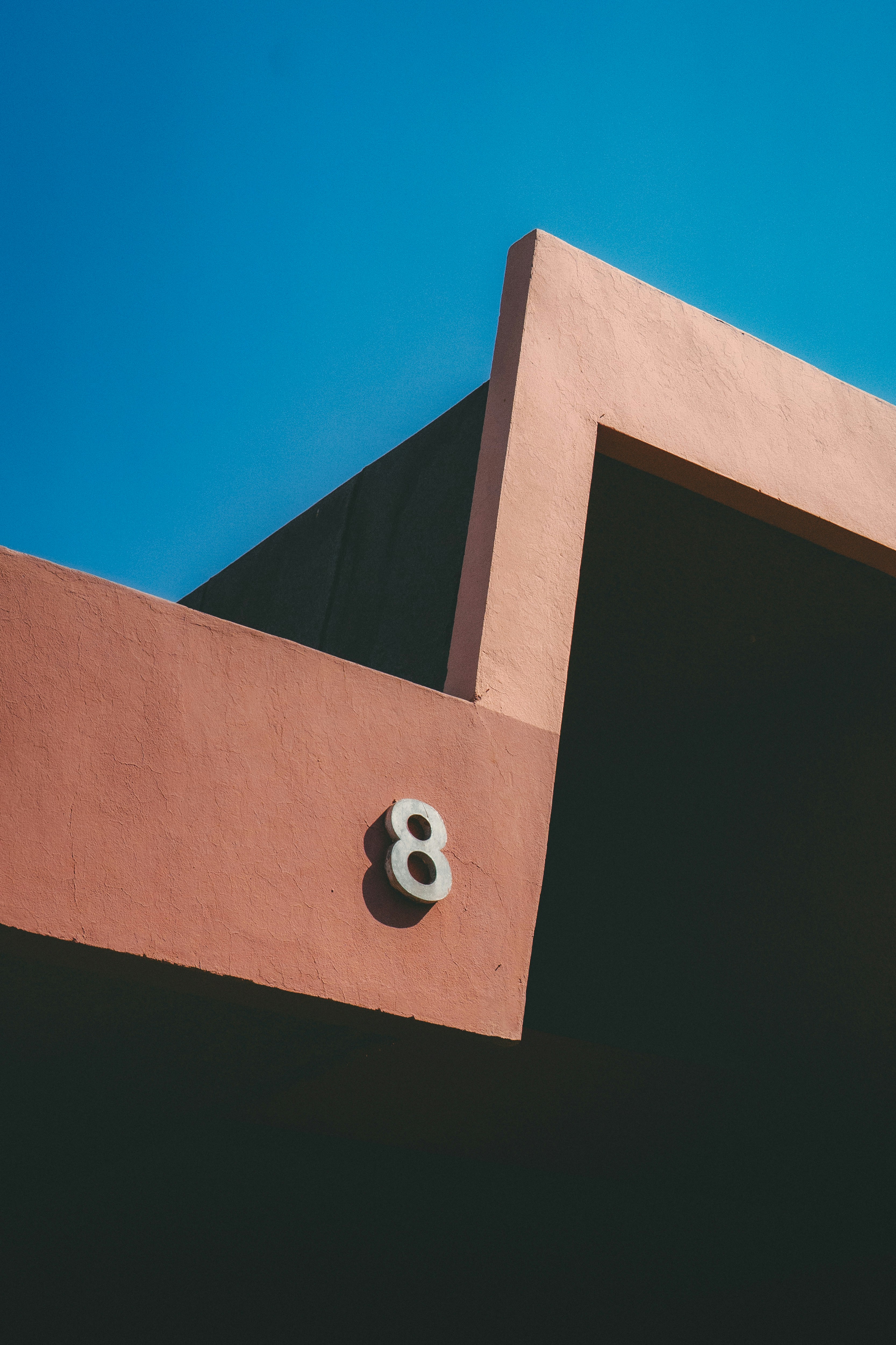 A pink building with the number eight