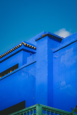 Vibrant blue building against a clear sky