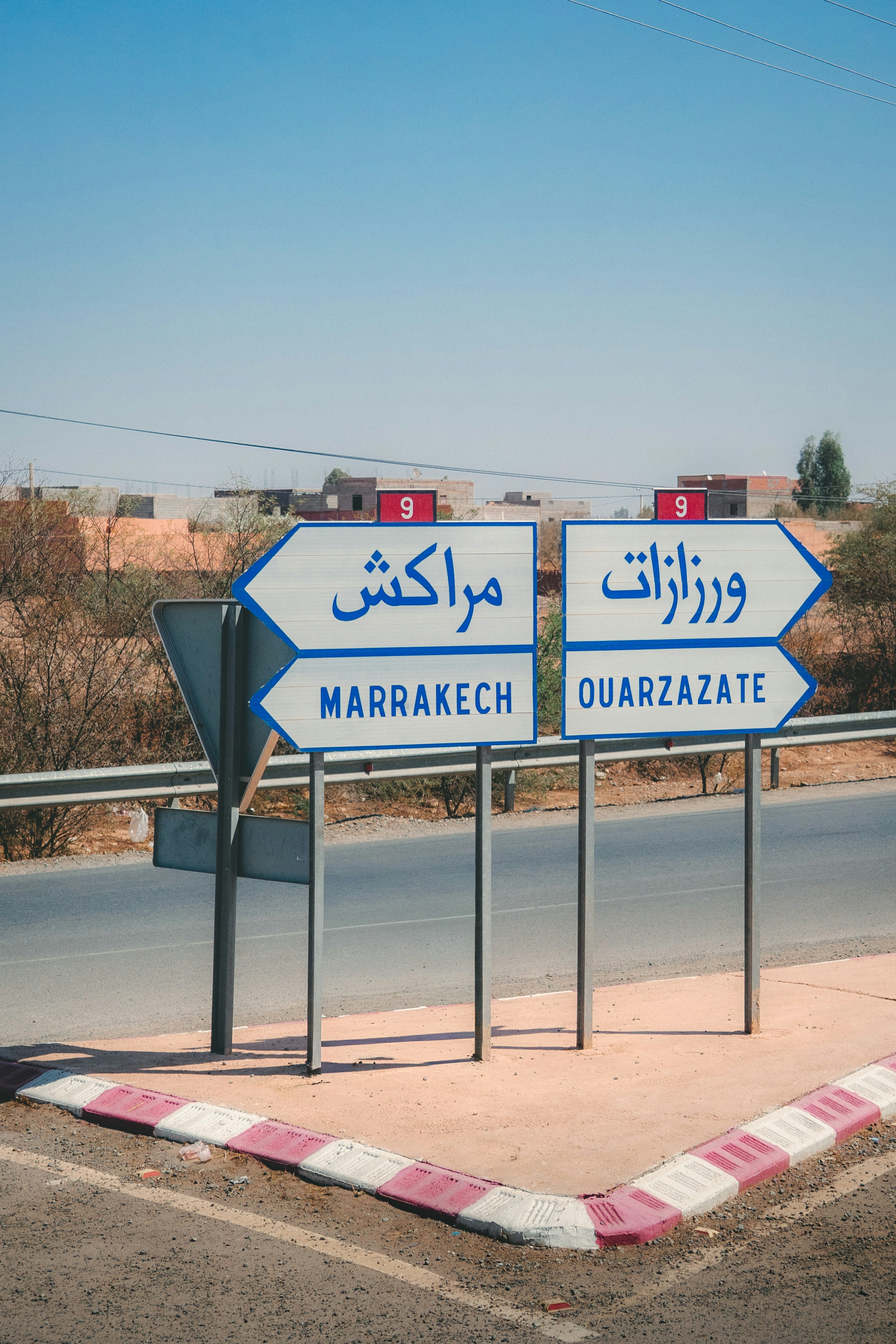 Road signs point to marrakech and ouarzazate
