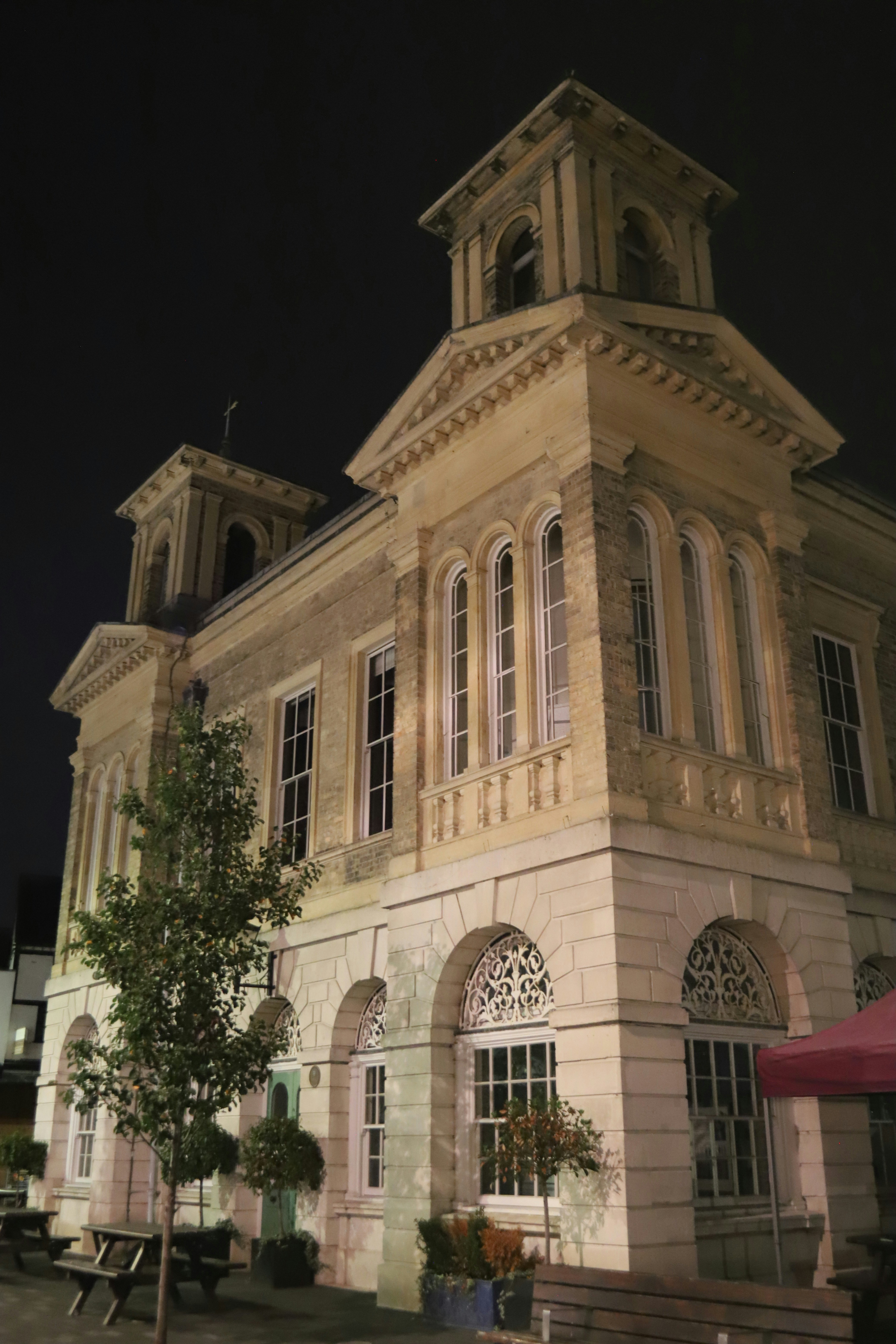 Ornate stone building with towers at night.