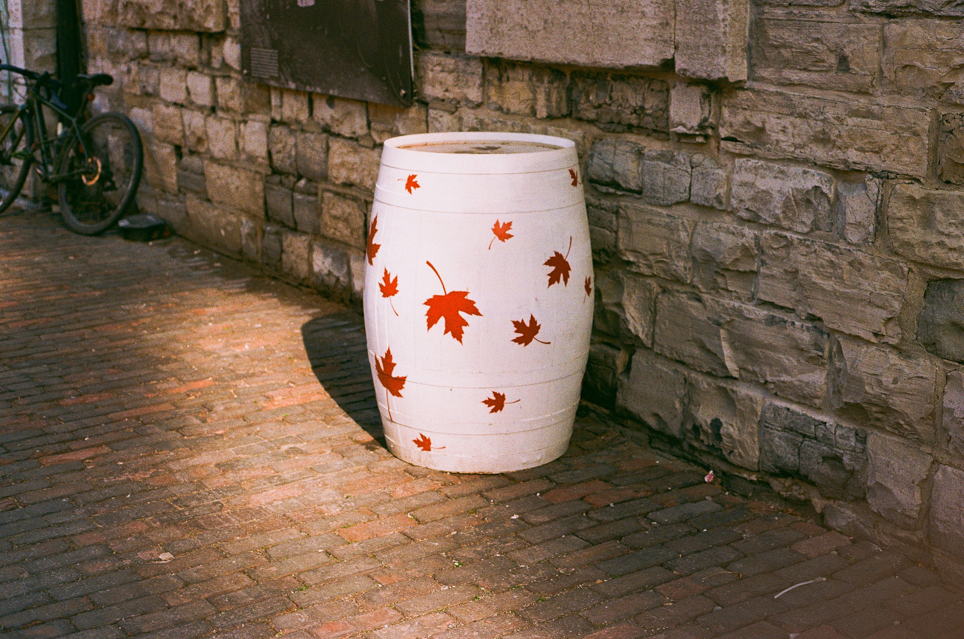 White barrel with red maple leaves pattern