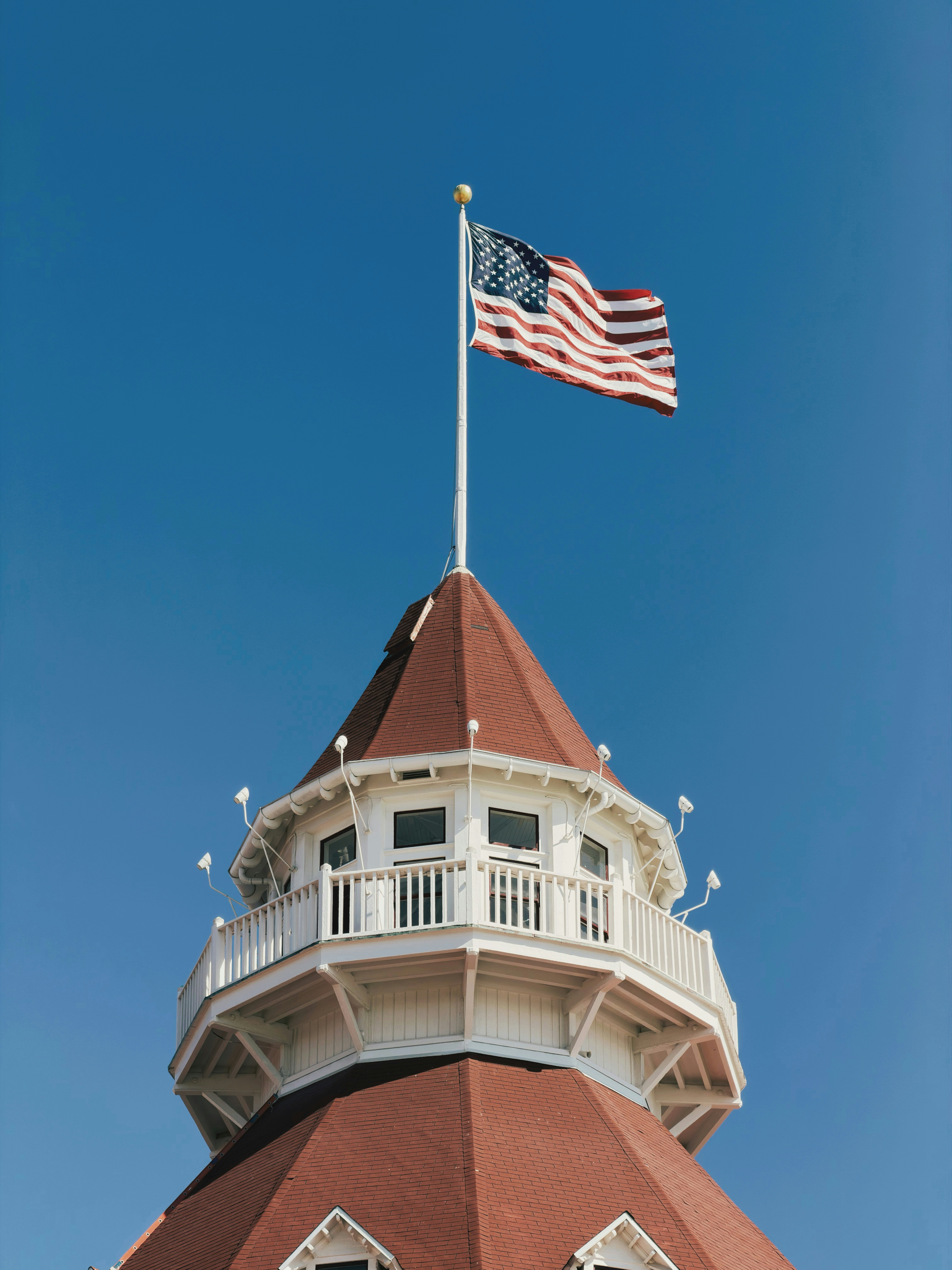 American flag waves atop a historic building
