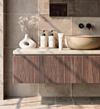 Modern bathroom vanity with sink and toiletries.