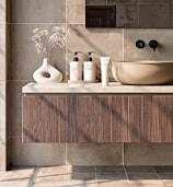 Modern bathroom vanity with sink and toiletries.