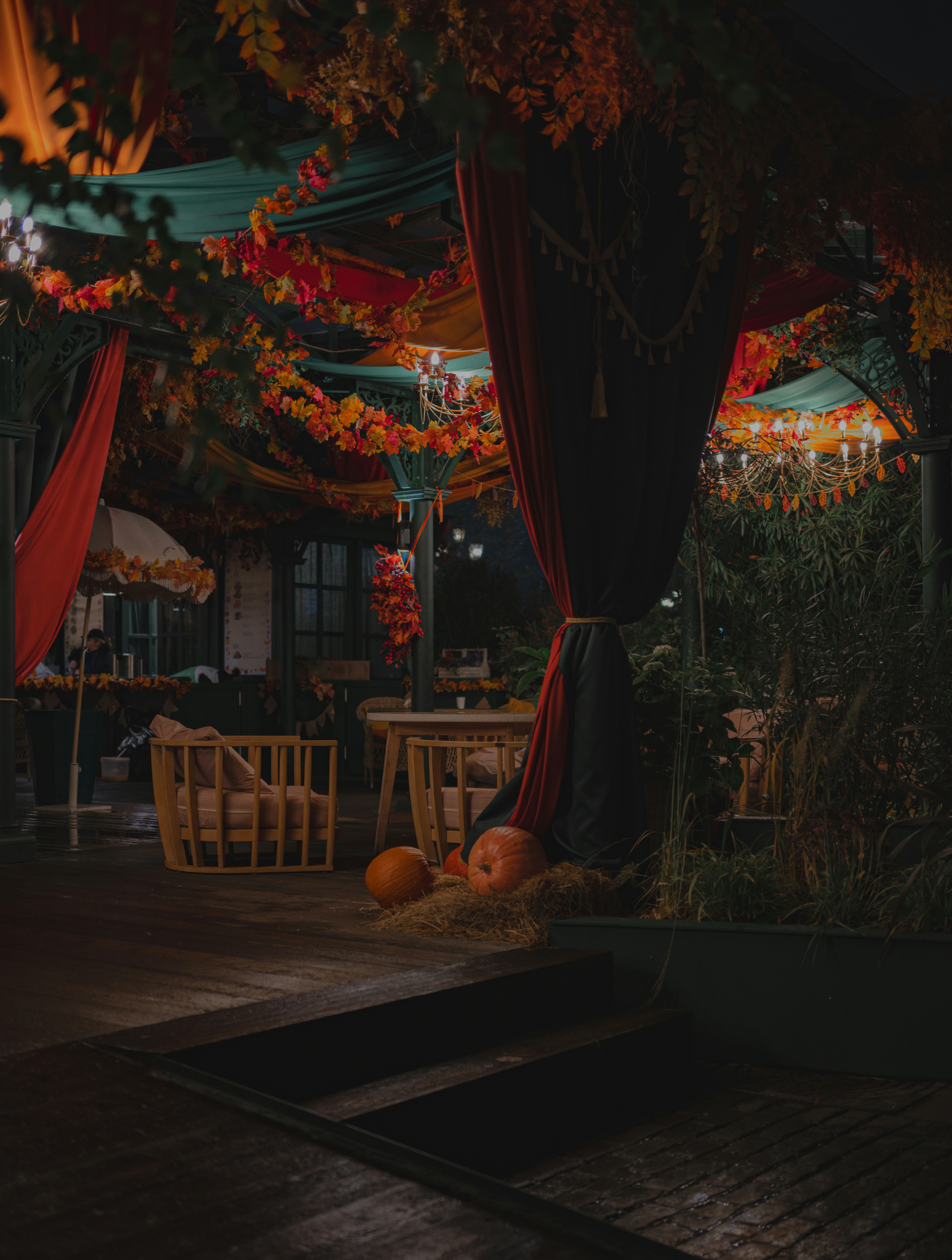Outdoor seating area decorated for autumn with pumpkins