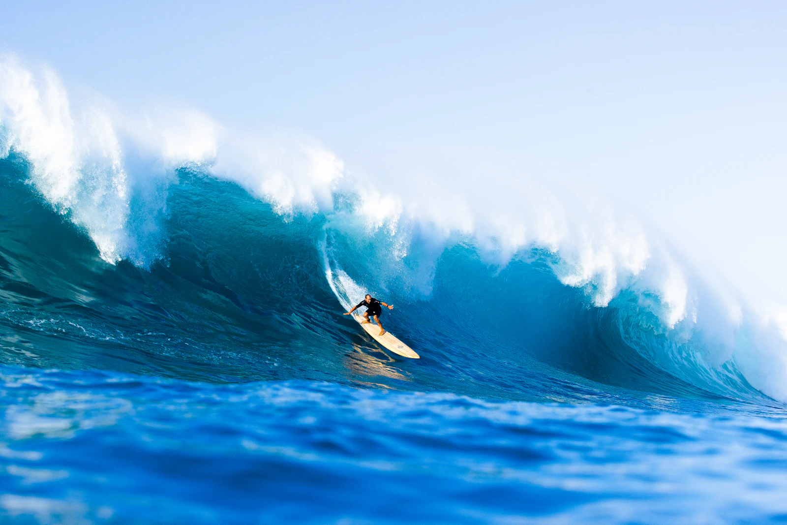 A surfer riding a massive wave