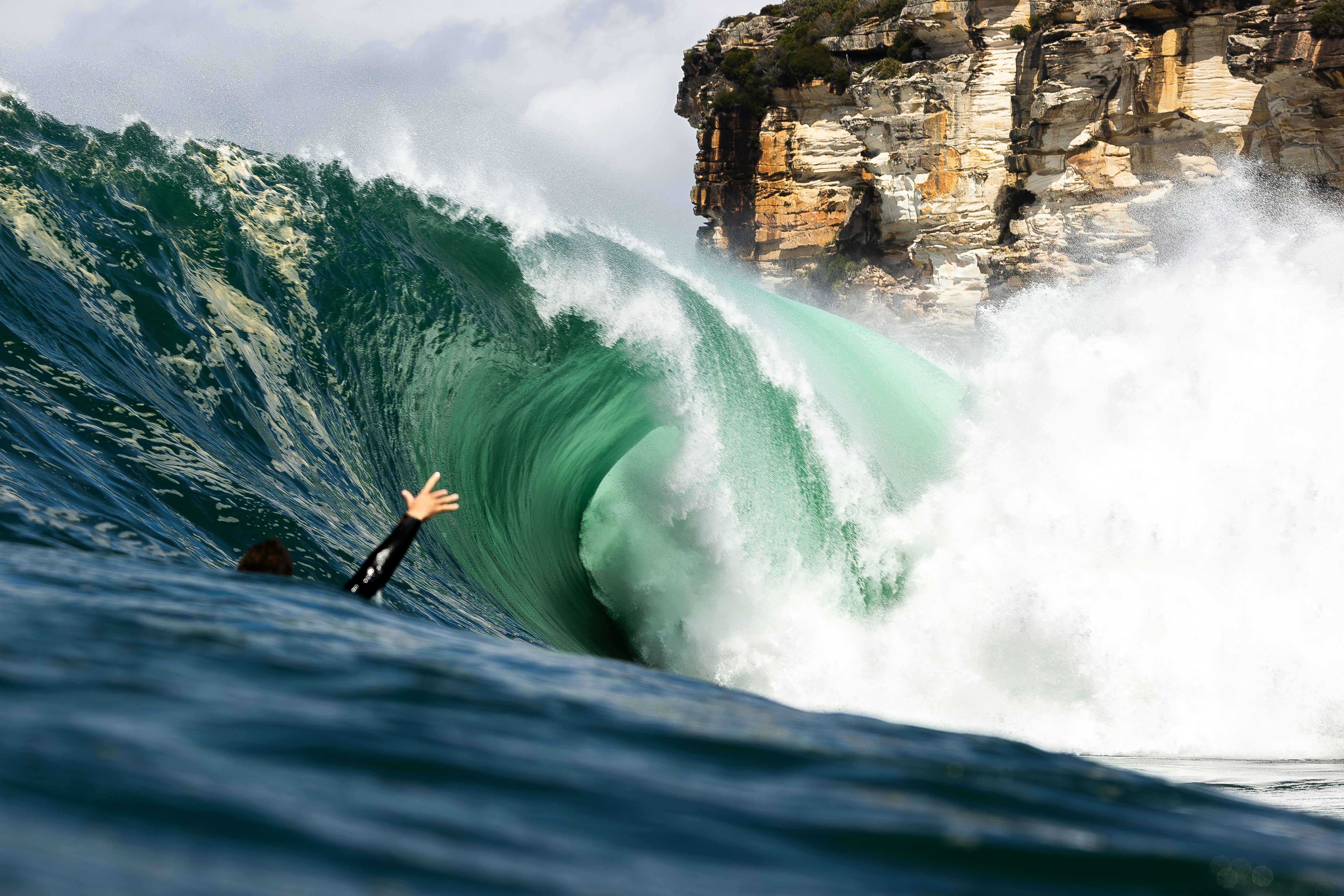 Surfer inside a large, powerful ocean wave