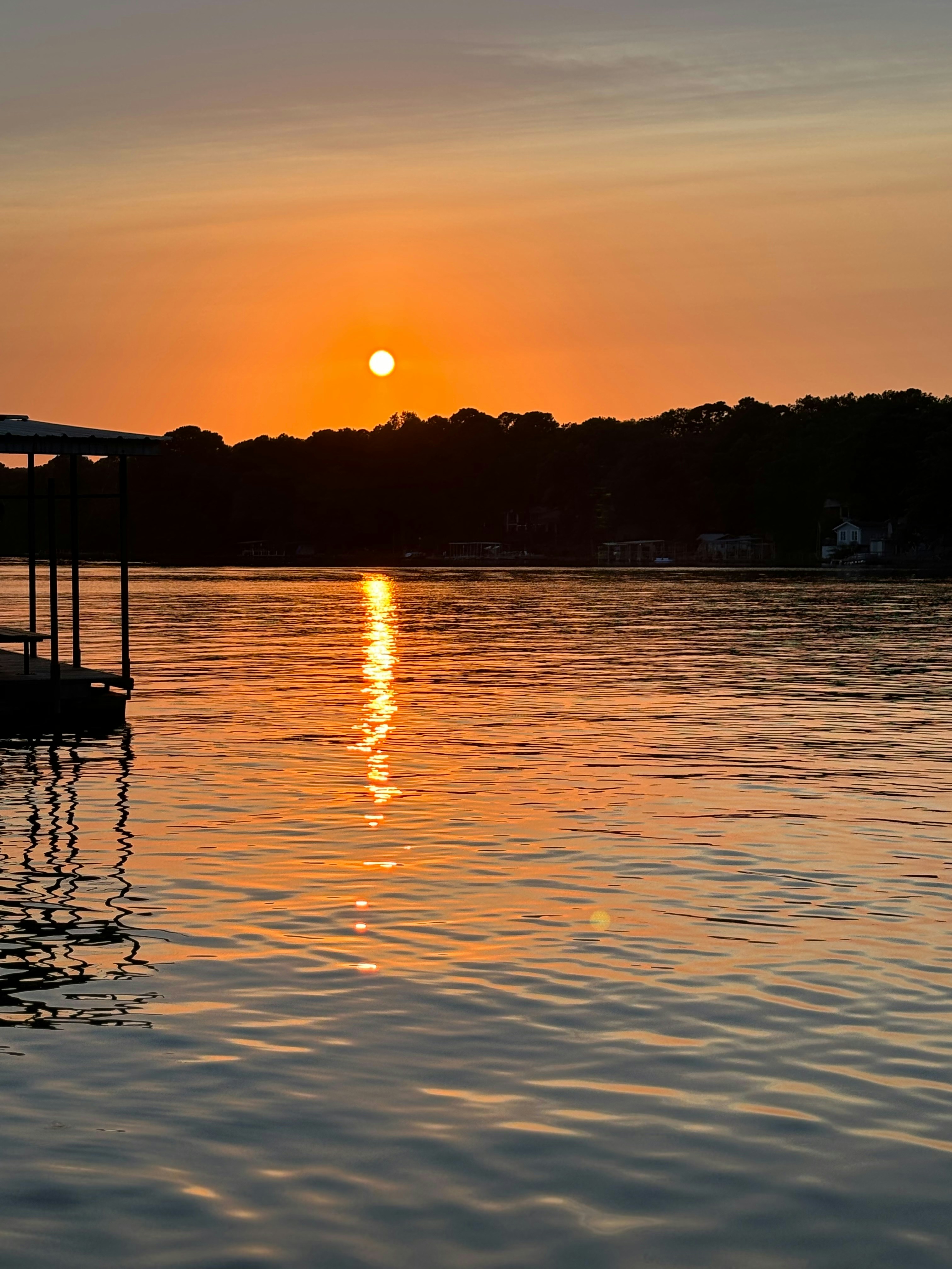Sunset over a calm lake with reflection