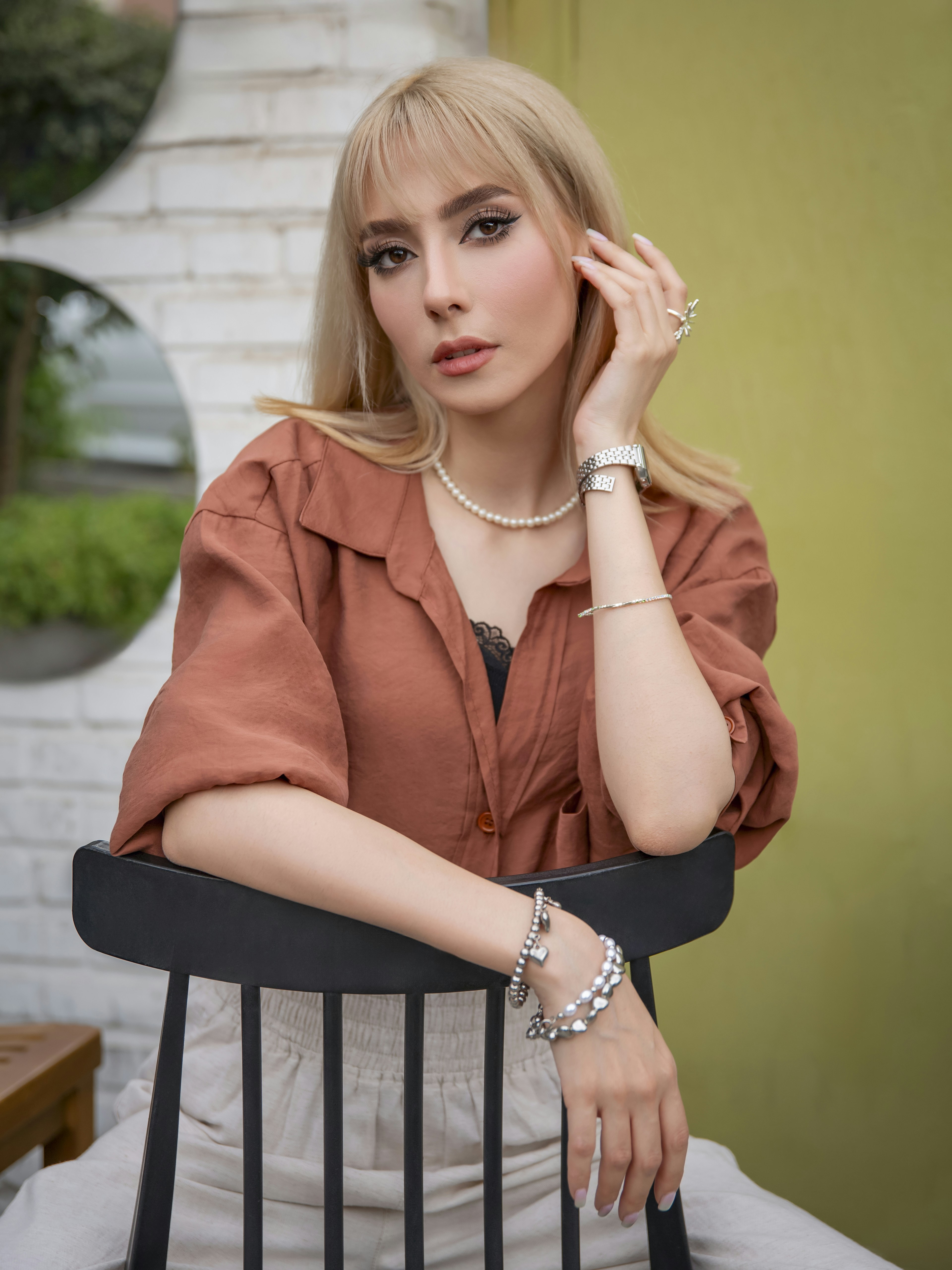 Blonde woman in casual clothing sitting on chair