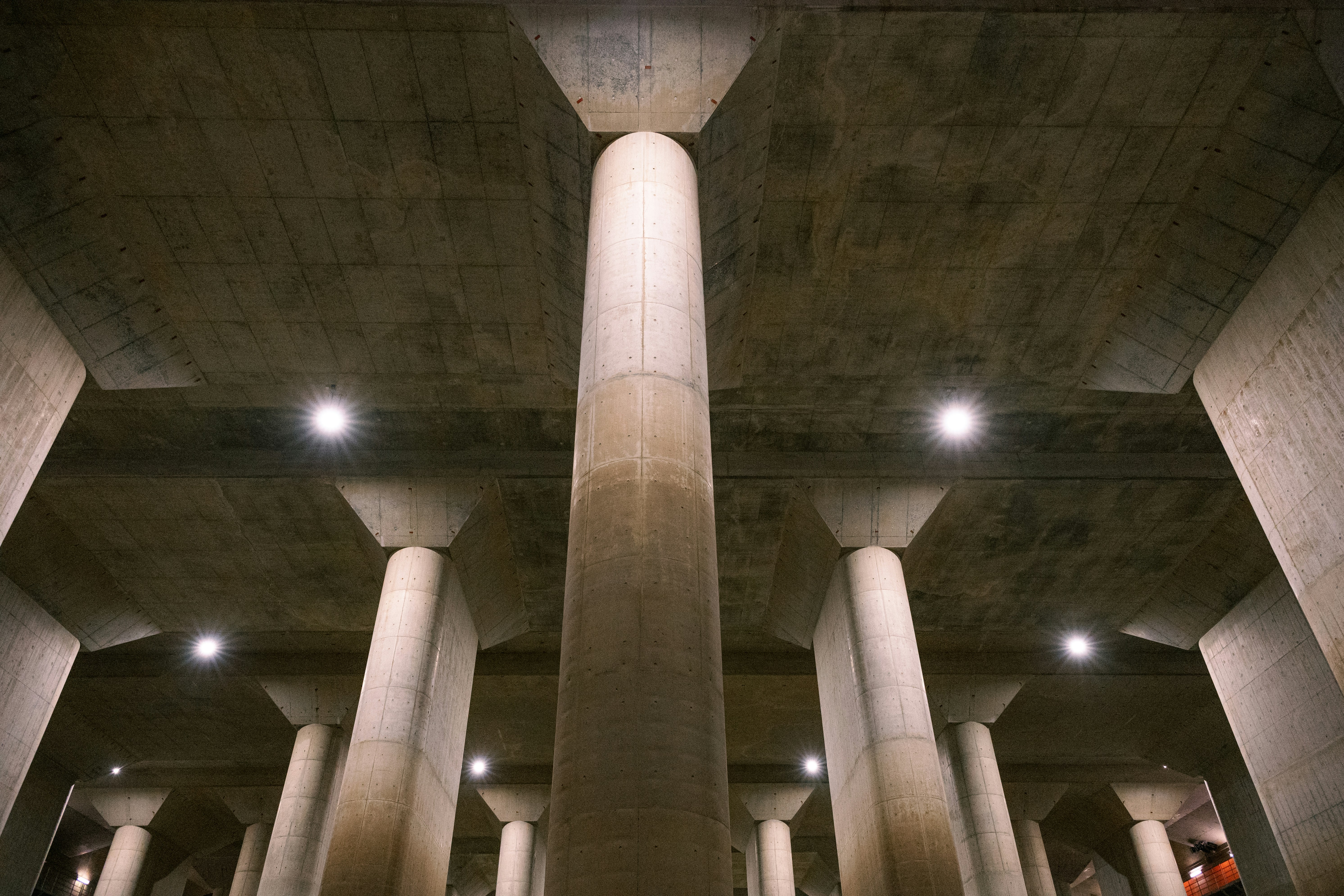 Massive concrete pillars supporting a ceiling.