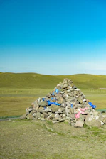 Cairn of rocks with blue and pink ribbons