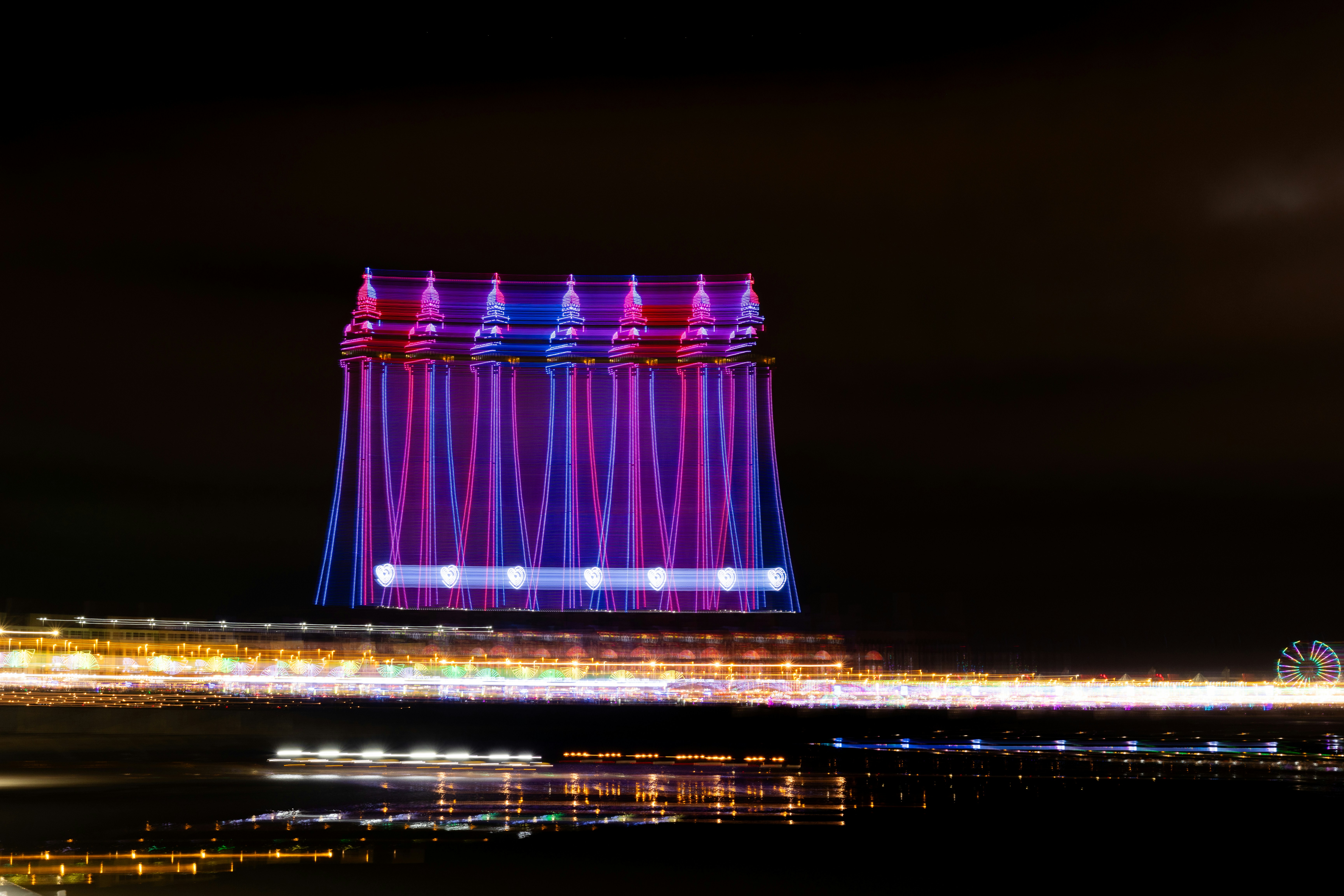 Colorful illuminated building against dark night sky