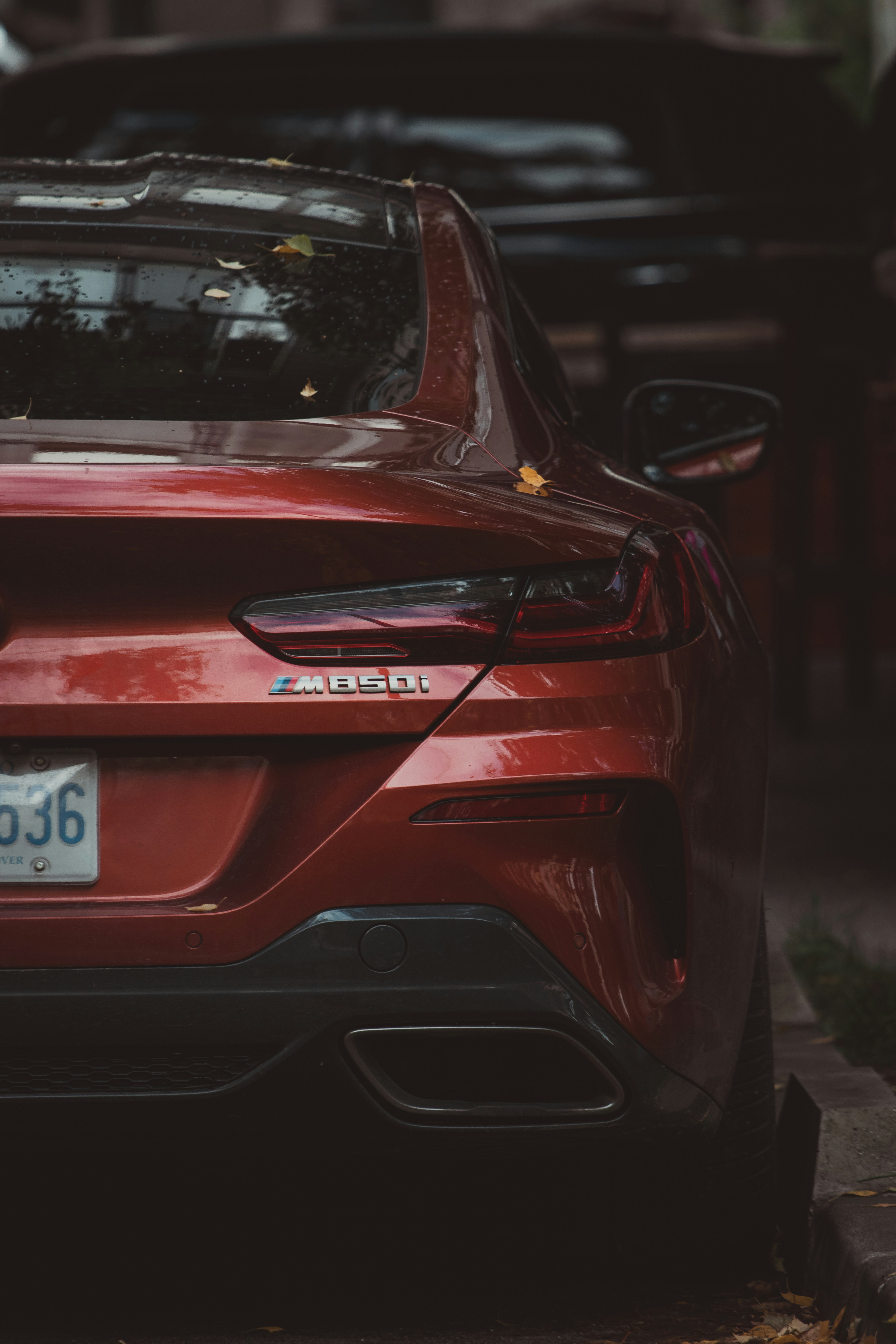Rear view of a red luxury car parked on street