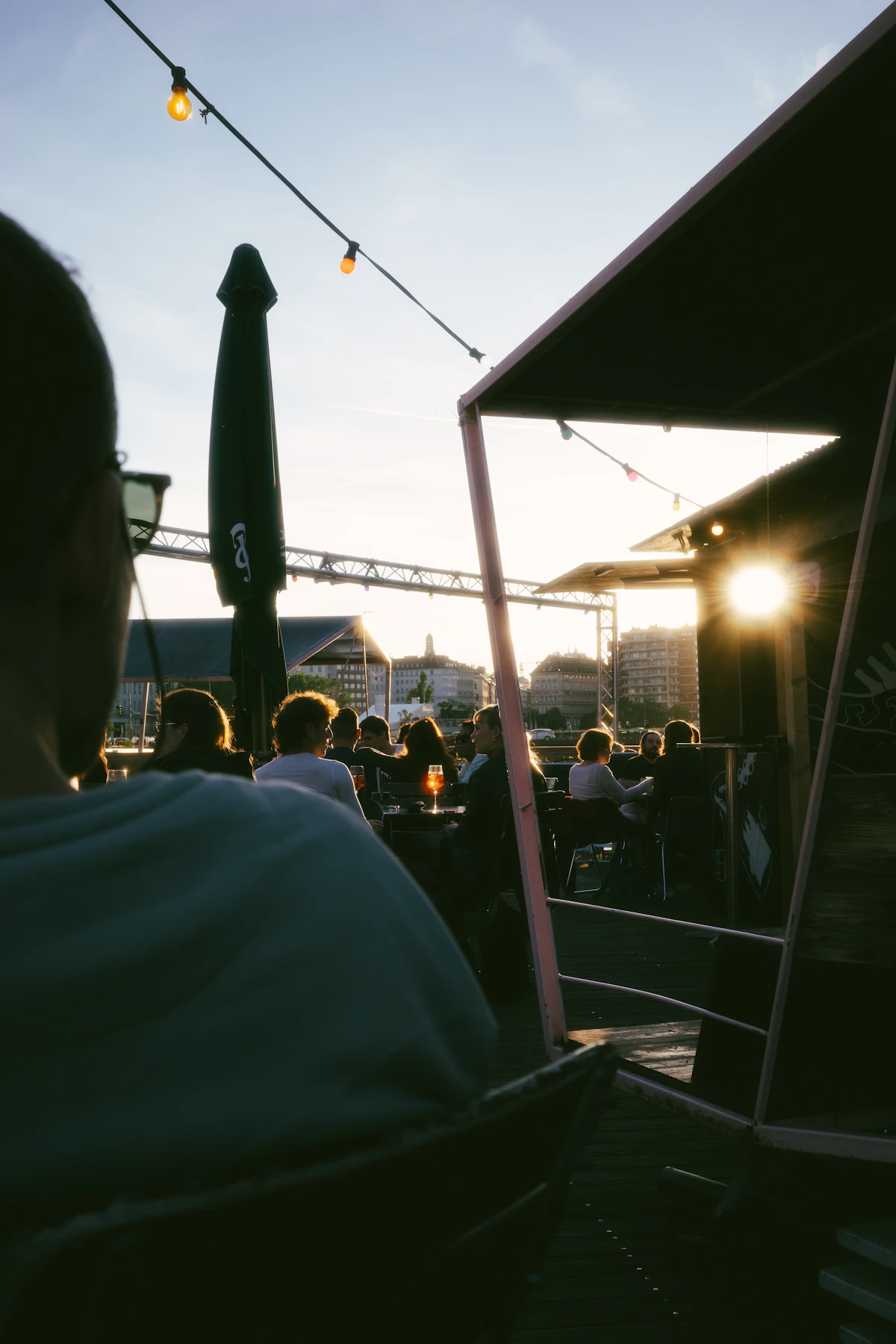 Travelers gathered on the roof deck at sunset