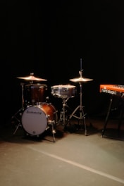 Drum set and keyboard on a dark stage