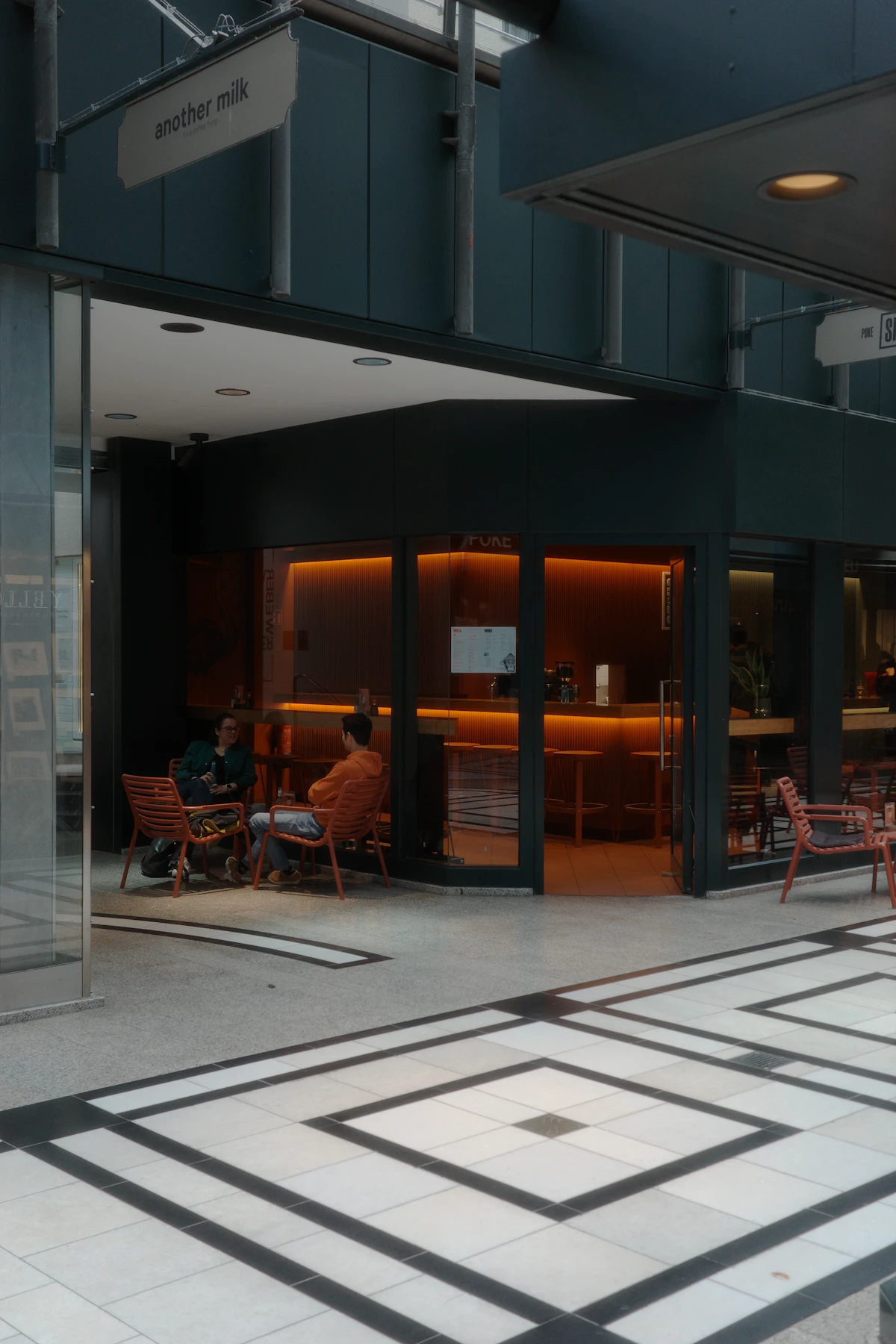 Two people meeting at a table in a busy café