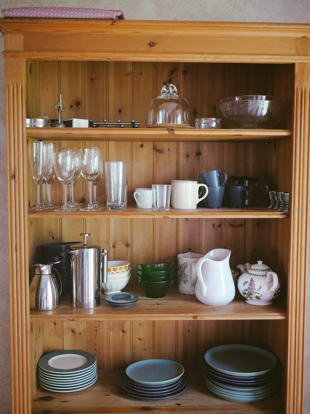 Pull-out shelf sliding out of a small kitchen cupboard